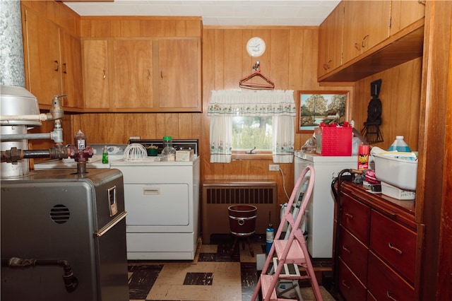 125 College St, Assumption, IL 62510 - washroom with radiator heating unit, washing machine and dryer, wood walls, and tile patterned floors