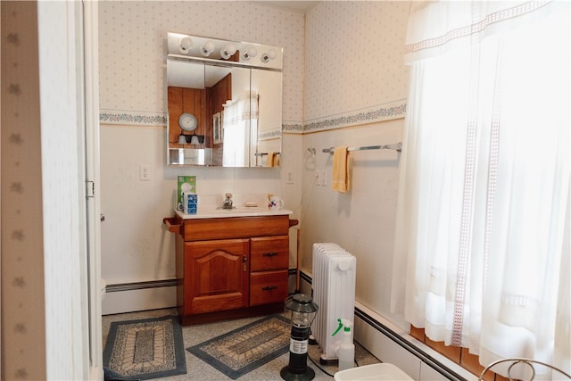 bathroom featuring radiator heating unit, vanity, and baseboard heating