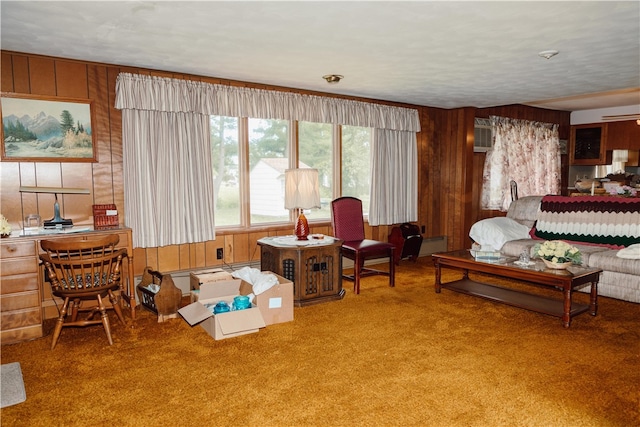 living room with carpet and wood walls