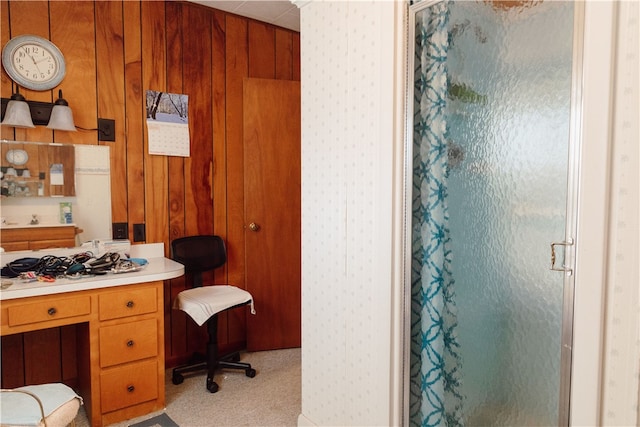 bathroom with a shower with door and wooden walls