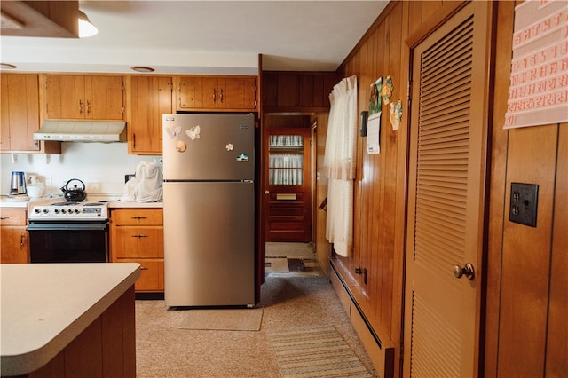 125 College St, Assumption, IL 62510 - kitchen featuring freestanding refrigerator, electric stove, under cabinet range hood, light countertops, and brown cabinetry