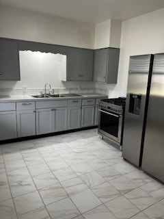 kitchen with gray cabinets, sink, and appliances with stainless steel finishes