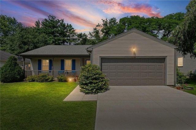 2506 Woodlawn Dr, Charleston, IL 61920 - ranch-style home featuring a porch, driveway, a front lawn, and an attached garage