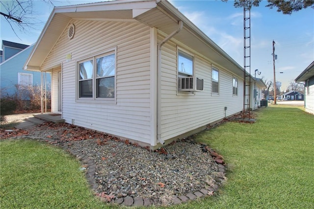 view of side of home featuring central AC unit, cooling unit, and a lawn