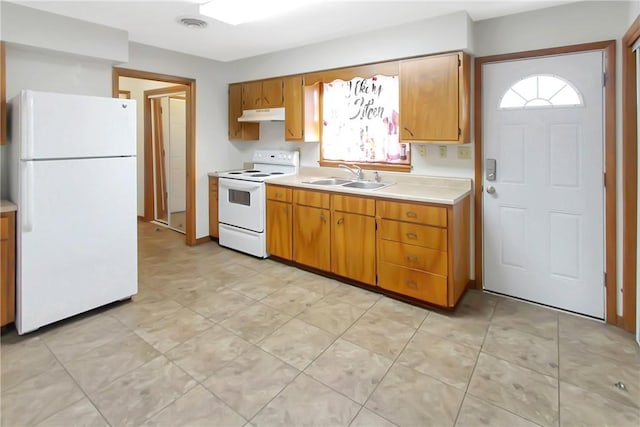 kitchen with visible vents, under cabinet range hood, light countertops, white appliances, and a sink