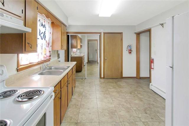 kitchen with under cabinet range hood, light countertops, baseboard heating, electric range, and a sink