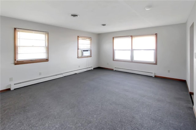 spare room featuring visible vents, cooling unit, a baseboard heating unit, and baseboards