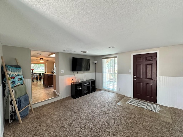 202 Seminary St, Catlin, IL 61817 - living room with a wainscoted wall, a textured ceiling, light carpet, and a ceiling fan