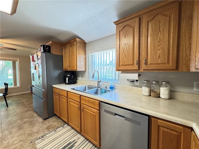 202 Seminary St, Catlin, IL 61817 - kitchen with appliances with stainless steel finishes, brown cabinetry, light countertops, light tile patterned floors, and a textured ceiling