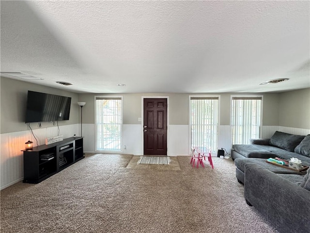 202 Seminary St, Catlin, IL 61817 - living area featuring wainscoting, a textured ceiling, and carpet flooring