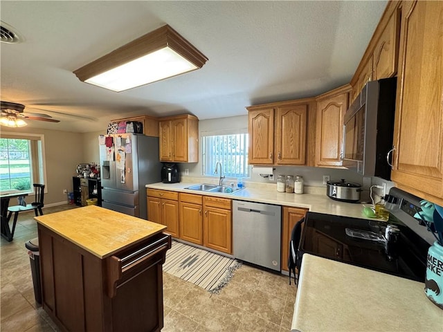 202 Seminary St, Catlin, IL 61817 - kitchen with stainless steel appliances, plenty of natural light, ceiling fan, and a center island