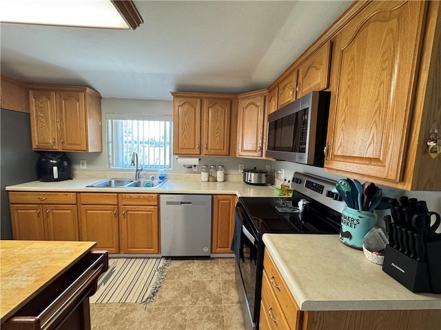 202 Seminary St, Catlin, IL 61817 - kitchen featuring stainless steel appliances, light countertops, and brown cabinetry
