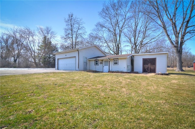 exterior space featuring a lawn, a garage, and driveway