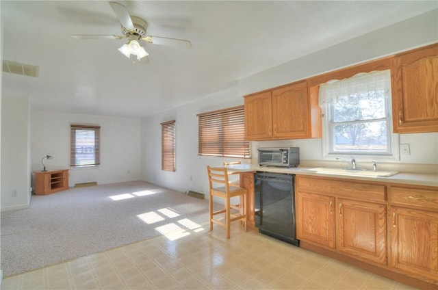 kitchen with light carpet, a sink, light countertops, dishwasher, and ceiling fan