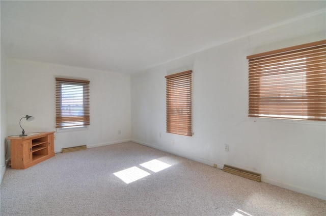 unfurnished room with visible vents, carpet, and baseboards