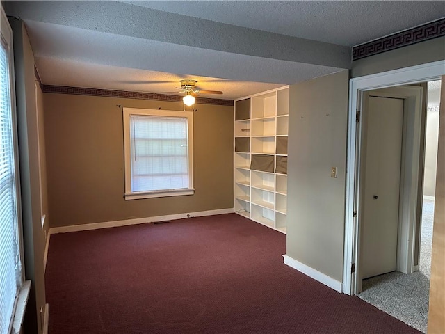 1821 Dakota Ave, Mattoon, IL 61938 - carpeted empty room with a textured ceiling, ceiling fan, and baseboards