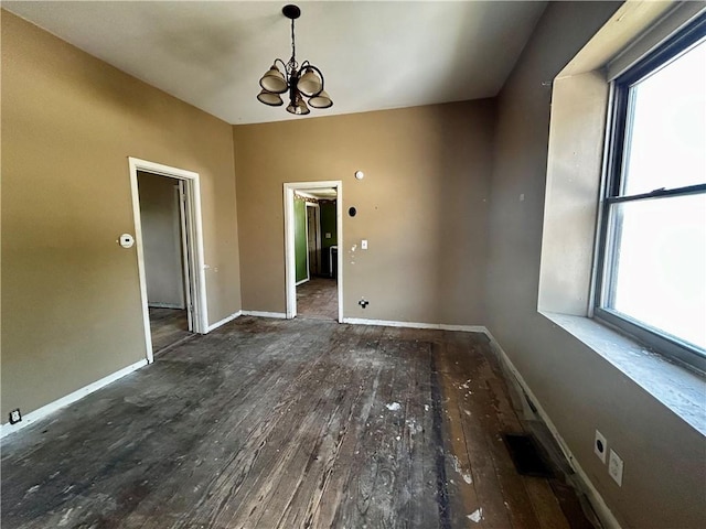 305 Bensyl Ave, Danville, IL 61832 - unfurnished dining area featuring a chandelier, healthy amount of natural light, and wood-type flooring