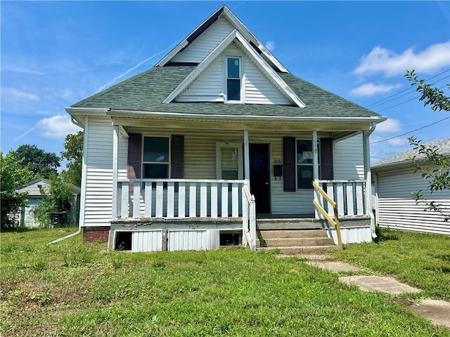 305 Bensyl Ave, Danville, IL 61832 - view of front of house with covered porch, roof with shingles, and a front lawn