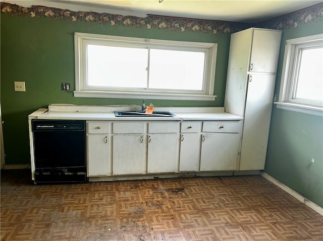 305 Bensyl Ave, Danville, IL 61832 - kitchen with black dishwasher, light countertops, and white cabinets