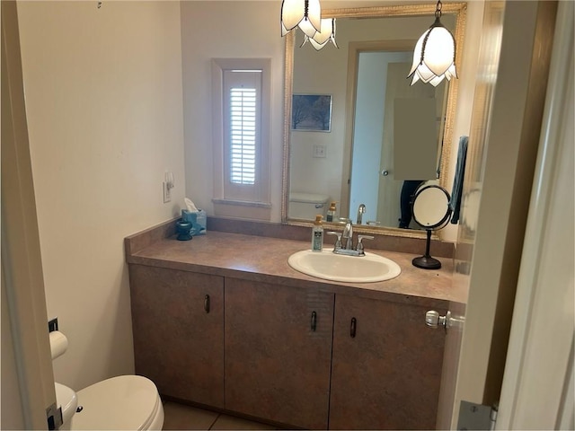 bathroom featuring tile patterned floors, vanity, and toilet