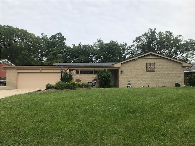 ranch-style house featuring a garage and a front lawn