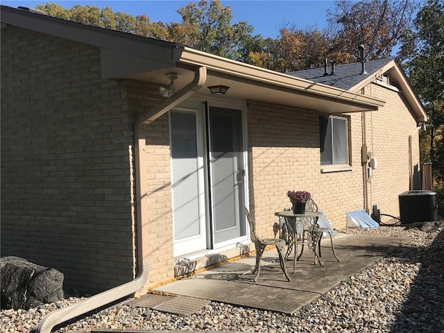 view of side of home featuring a patio area and cooling unit