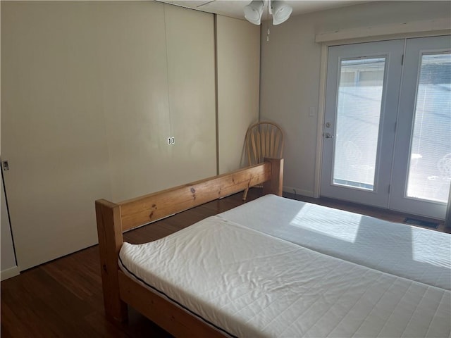 bedroom with dark hardwood / wood-style floors