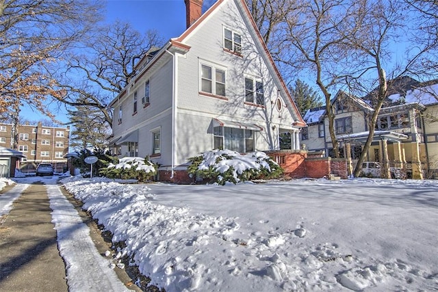 view of snow covered rear of property