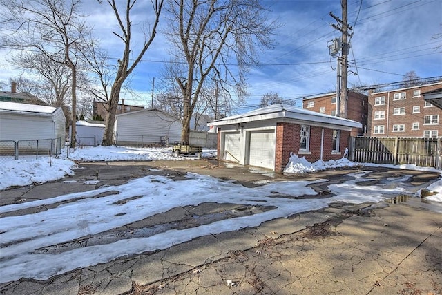 exterior space with a garage and an outdoor structure