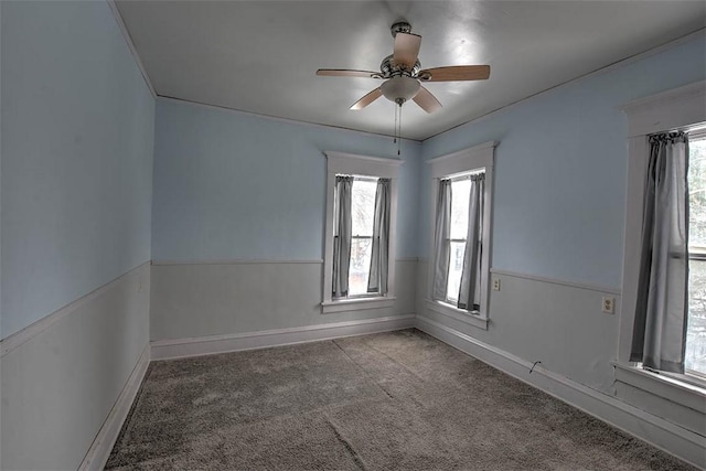 unfurnished room featuring ceiling fan and carpet