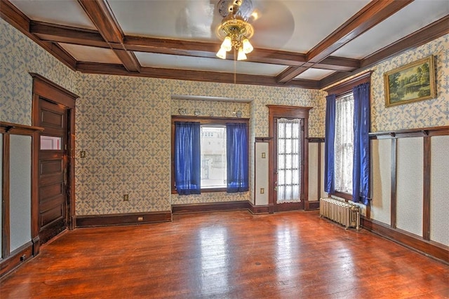 unfurnished room with radiator heating unit, wood-type flooring, ceiling fan, beam ceiling, and coffered ceiling