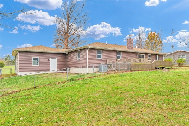 rear view of house with a yard and central air condition unit