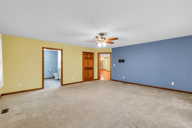 carpeted spare room featuring ceiling fan