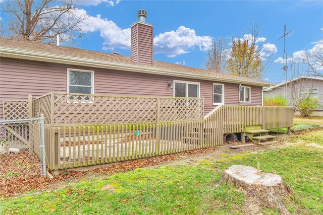 back of house with a lawn and a wooden deck