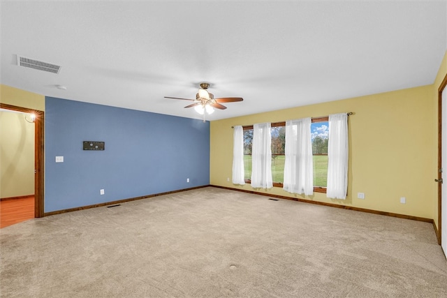 unfurnished room featuring ceiling fan and light colored carpet