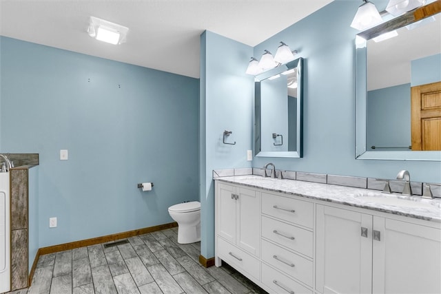 bathroom with hardwood / wood-style flooring, vanity, and toilet