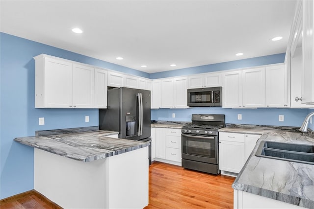 kitchen featuring white cabinets, stainless steel appliances, and sink