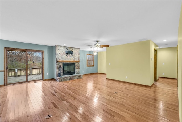 unfurnished living room featuring a fireplace, light wood-type flooring, and ceiling fan