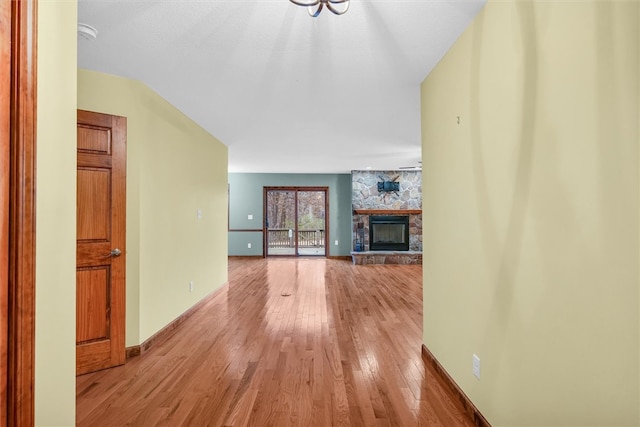 unfurnished living room with a fireplace and light hardwood / wood-style flooring