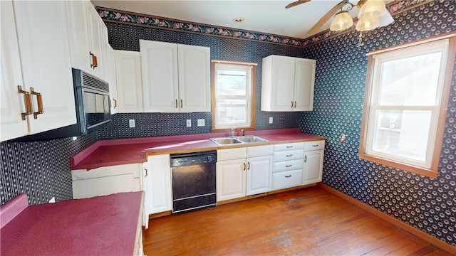 kitchen featuring white cabinets, sink, light hardwood / wood-style flooring, black dishwasher, and built in microwave