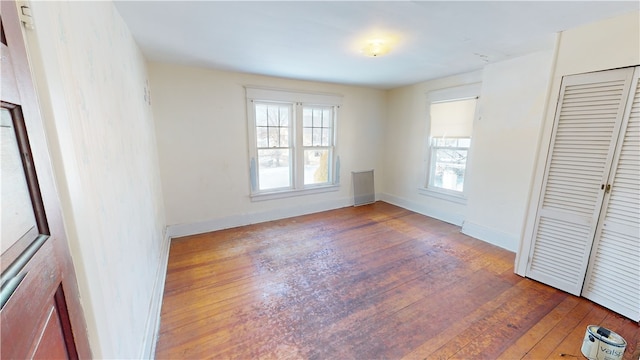 unfurnished bedroom featuring dark hardwood / wood-style flooring and a closet