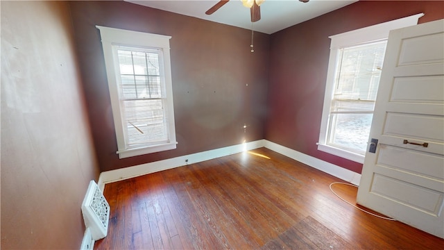 empty room with ceiling fan and hardwood / wood-style flooring