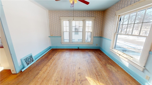 empty room with wood-type flooring and ceiling fan