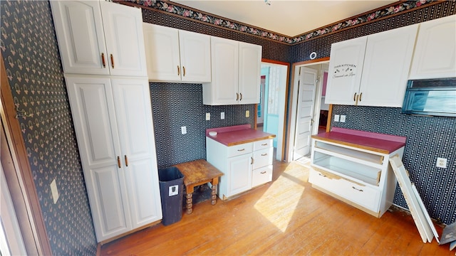 kitchen featuring white cabinetry and light wood-type flooring