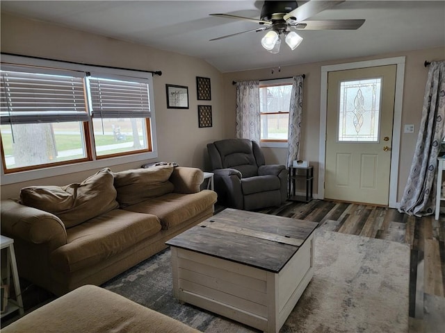 living area featuring lofted ceiling, wood finished floors, and ceiling fan