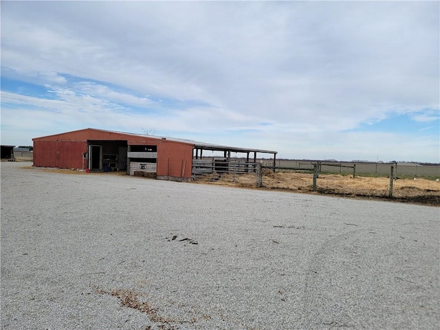 view of pole building featuring fence