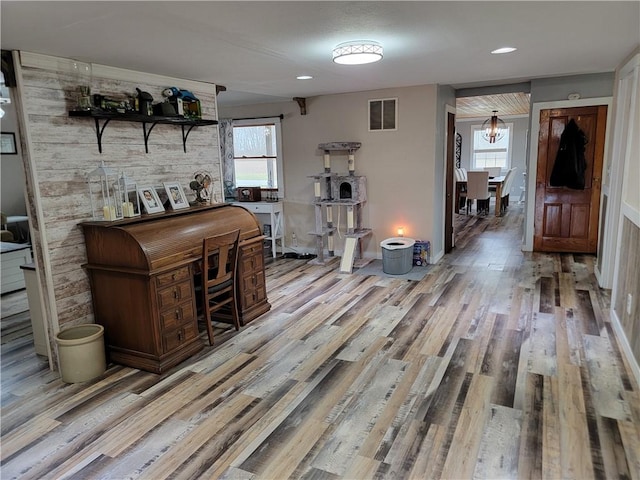 interior space featuring visible vents, wood finished floors, and plenty of natural light