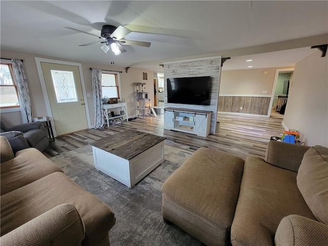 living room featuring ceiling fan and wood finished floors