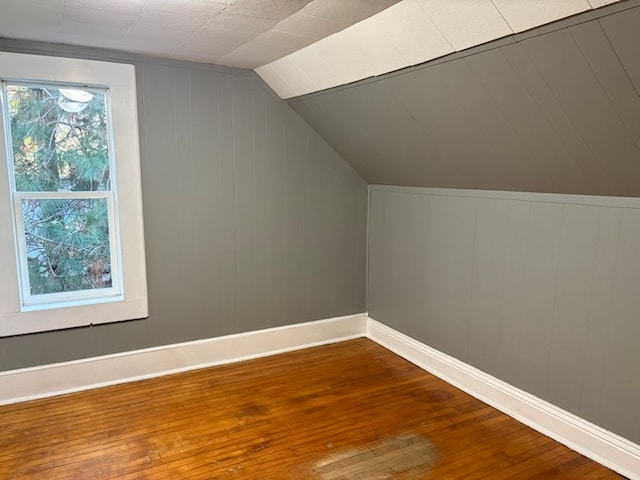 bonus room featuring hardwood / wood-style floors and vaulted ceiling