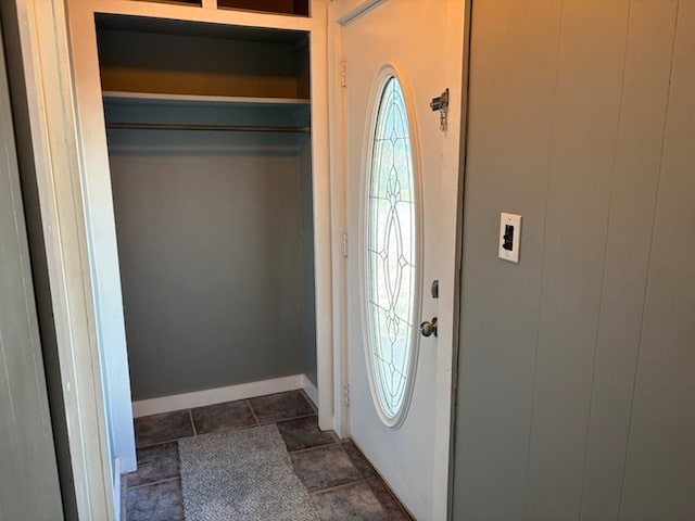 foyer entrance featuring dark tile patterned floors